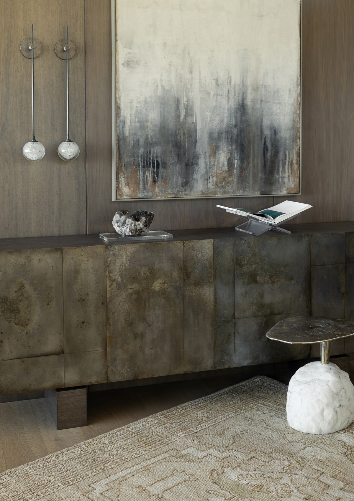 Textured rug in an interior with art and a sculptural cabinet