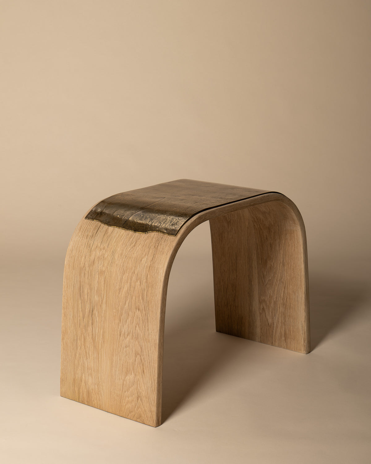 Alternate photograph of Veil, showing its brass seat and curved oak form.