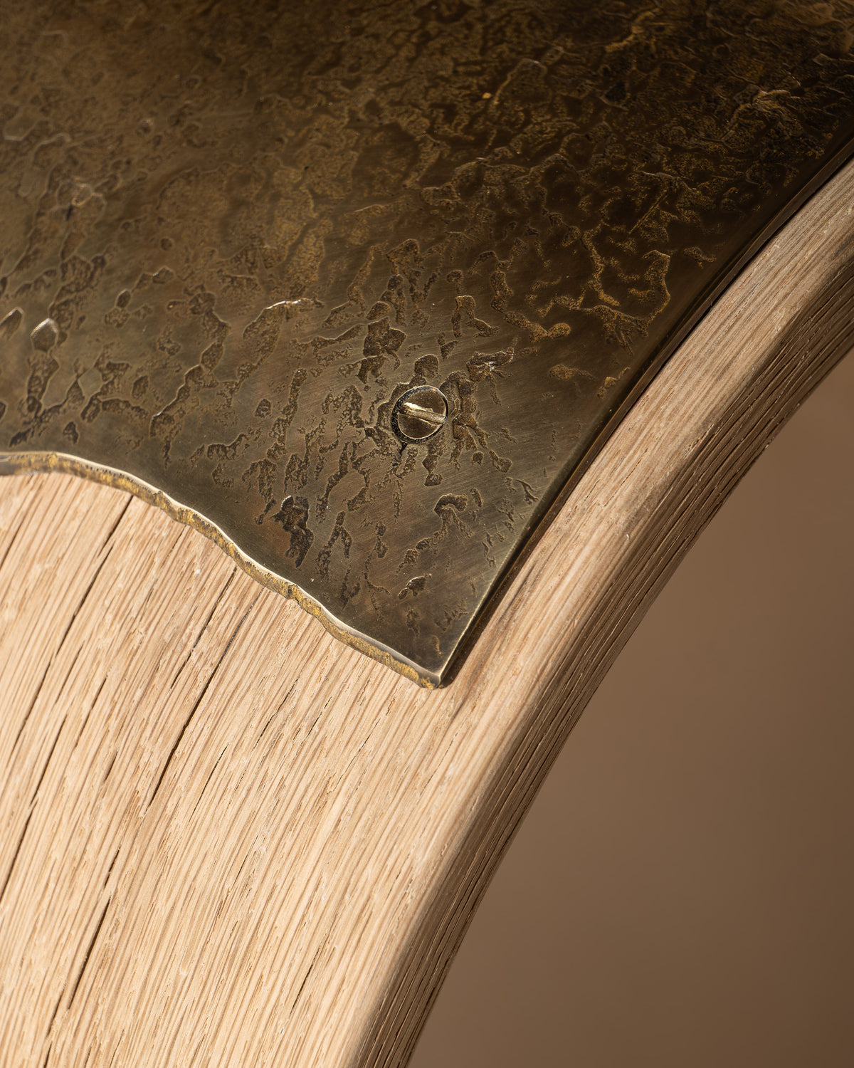 Close-up of Veil's textured brass seat and irregular edge.