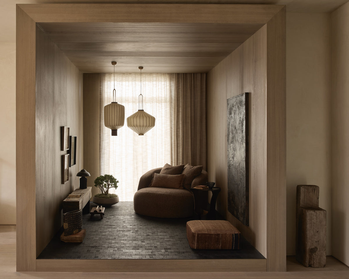 The Jewelry Box room in AMB Design’s Shibui project, with warm wood, sculptural seating, and pendant lights