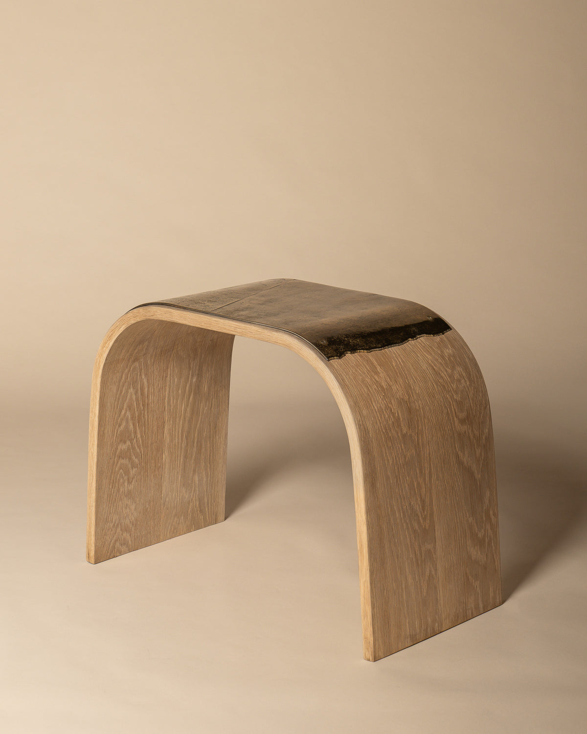 Veil bench viewed from the opposite side, showing the brass seat over the curved oak.