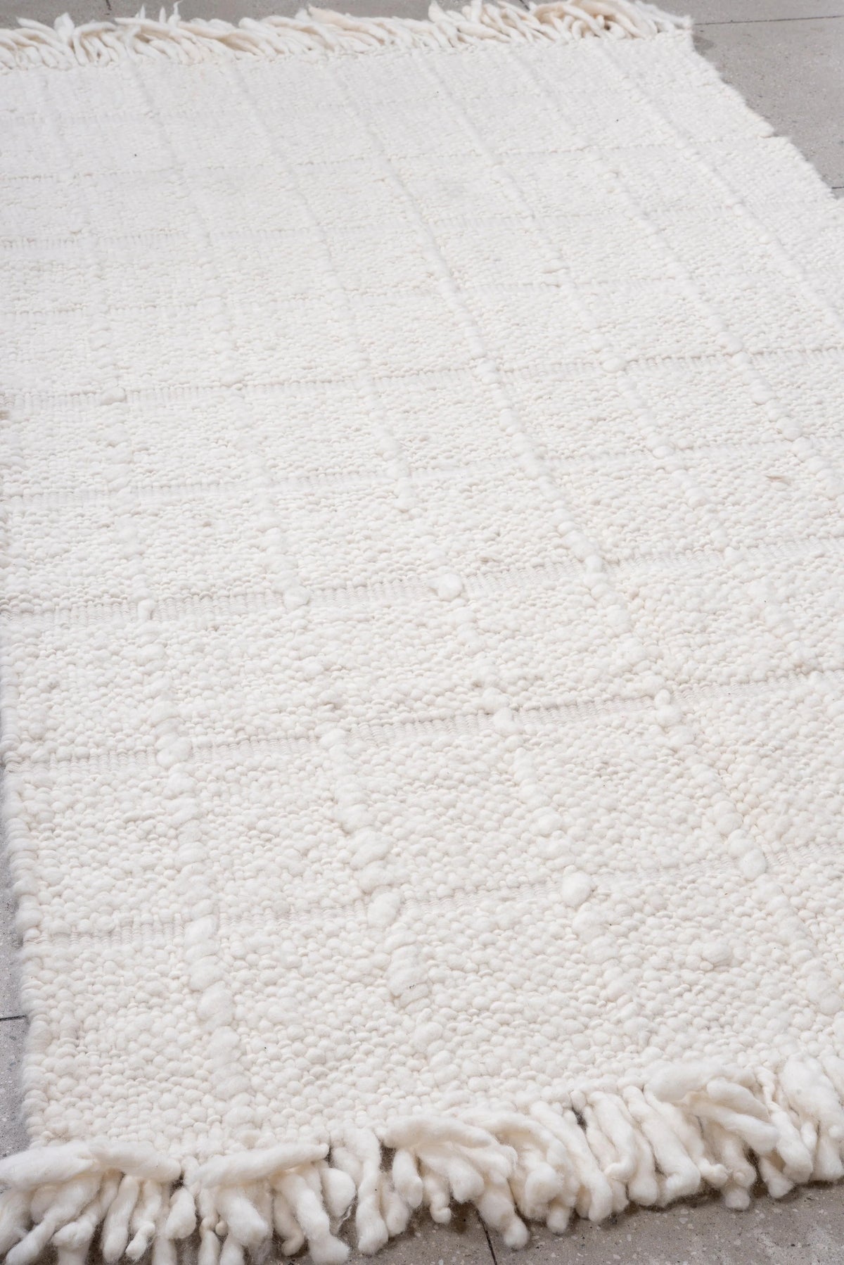 Paloma’s woven wool surface and fringe